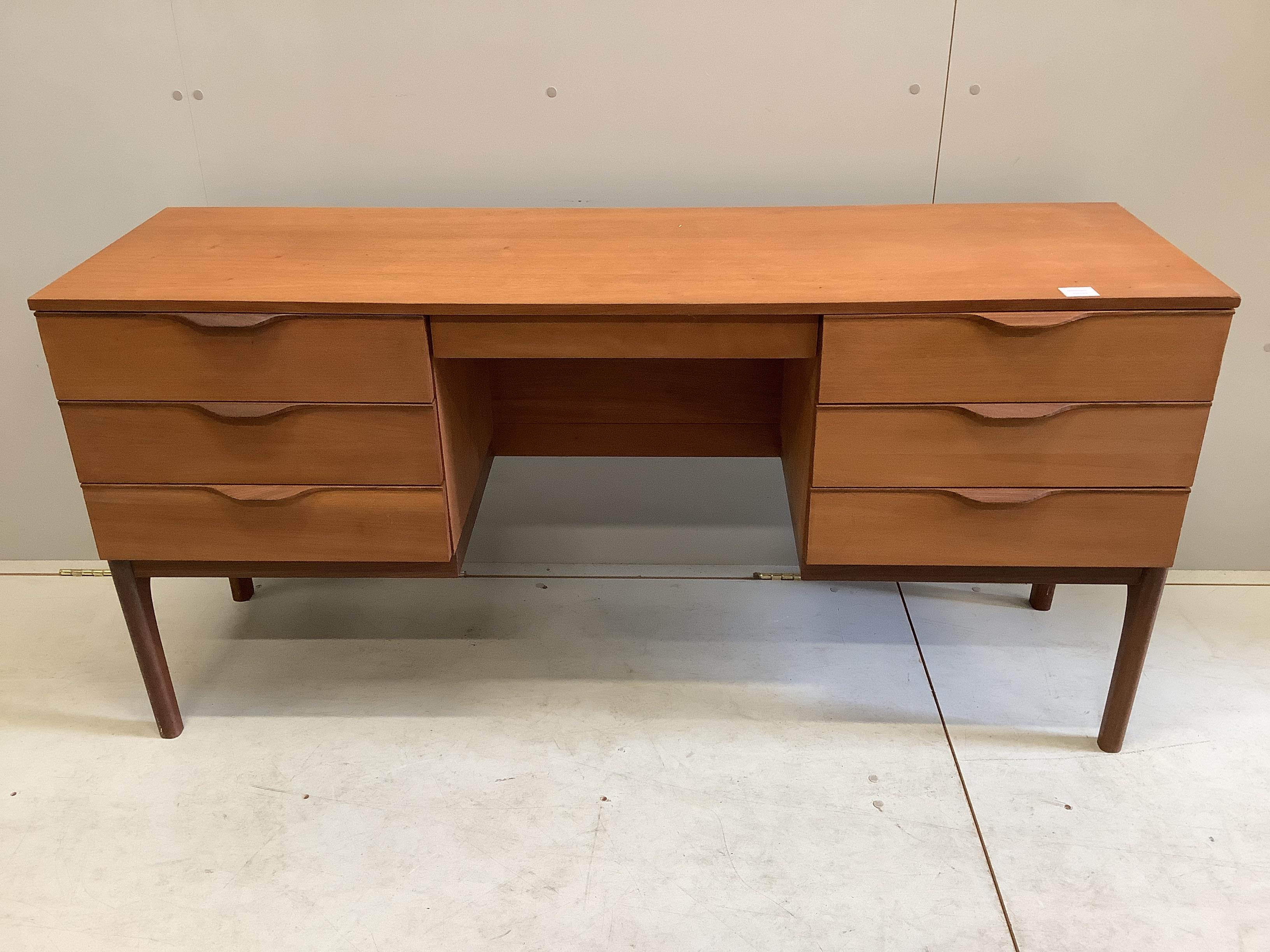 A mid century Europa teak dressing table, width 150cm, depth 45cm, height 73cm